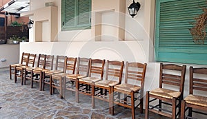 Row of wooden chairs on house front