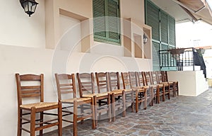 Row of wooden chairs on house front