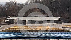 Row of wooden seats on a spectator grandstand photo. Bench for the show