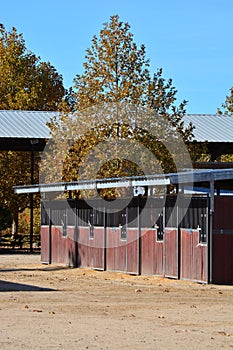 Row of Wooden shedrow stabling at Twin Rivers Ranch