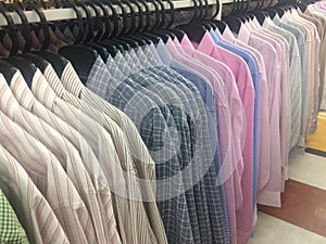 Row of working shirt hanging orderly on cloth shop