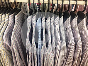 Row of working shirt hanging orderly on cloth shop