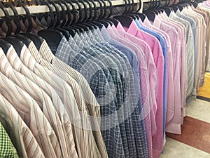 Row of working shirt hanging orderly on cloth shop