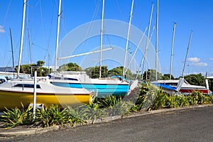 A row of yachts, stored out of the water