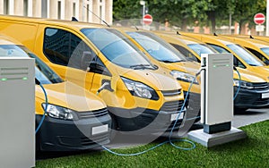 Row of yellow electric delivery vans at charging stations