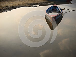 Rowboat Floating on Still Waters