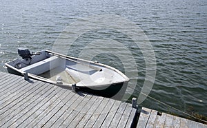 Rowboat by a wood pier