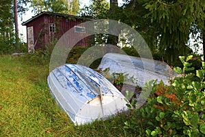 Rowboats in front of red shed