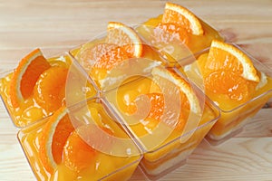 Rowed up Mandarin Orange Cakes Topped with Fresh Oranges in Glass Bowls