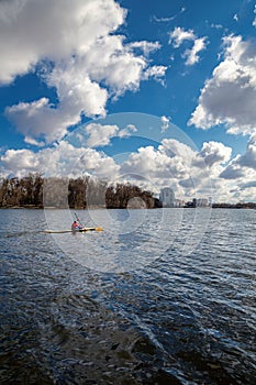 Rowers in kayaks on the river on a spring day