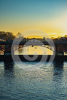 Rowers Silhouetted at Sunrise Behind a Bridge on the River Clyde in Glasgow Scotland