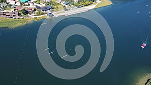 Rowers training aerial. People paddle among islands on a lake. Sparkling blue Water on a Sunny Day. Aerial view of