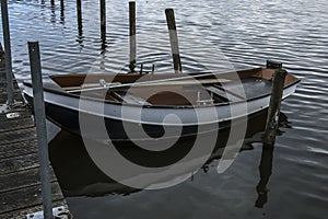 Rowing boat at landing stage in river Oude Ijssel