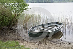 Rowing boat moored lake loch reeds single one lonely scenic national park uk
