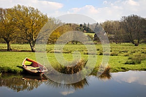 Rowing boat on river bank