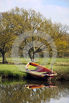 Rowing boat on river bank