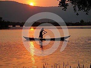 Rowing Boat Silhouette on Tropical River