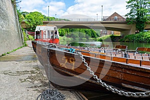 Rowing boats lined up on the Wear river in the city centre of Durham