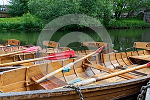 Rowing boats lined up on the Wear river in the city centre of Durham