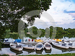 Rowing boats and pedal boats for rent at the landing stage in the lake