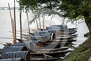 Rowing boats on the river bank in rural area. West Bengal, India. Rural landscape