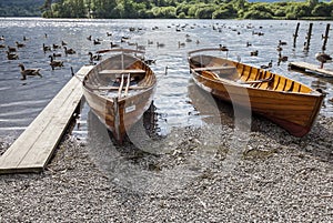 Rowing boats on shore of Derwent Water, Keswick.