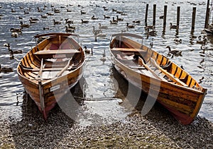 Rowing boats on shore of Derwent Water, Keswick.