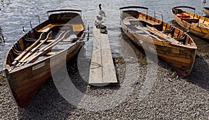 Rowing boats on shore of Derwent Water, Keswick.