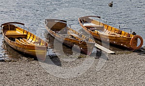 Rowing boats on shore of Derwent Water, Keswick.