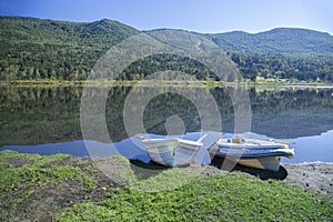 Rowing boats on the shore of a mountain lake