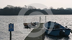 Rowing boats tied up to a dock during the cold winter months in Hornsea