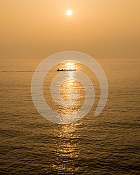 Rowing Crew Across The Sunset A