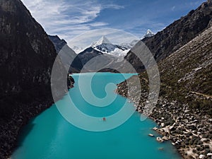 Rowing paddle boat on blue turquoise alpine mountain lake Laguna Paron in Caraz Huaraz Ancash Cordillera Blanca Peru