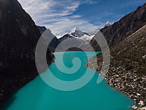 Rowing paddle boat on blue turquoise alpine mountain lake Laguna Paron in Caraz Huaraz Ancash Cordillera Blanca Peru