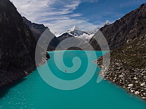 Rowing paddle boat on blue turquoise alpine mountain lake Laguna Paron in Caraz Huaraz Ancash Cordillera Blanca Peru