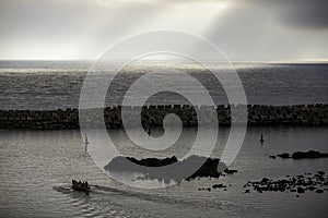 Rowing at sea in Lajes dor Pico, Azores. Rowing in copies of the whalers rowing boats.