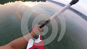 Rowing on a SUP board. Of the first person. The camera is on a paddle.