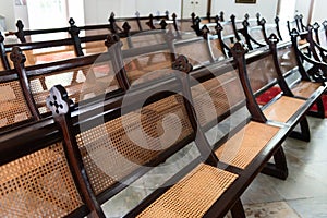 Rows of Antique, Handcrafted Pews in an Old Church