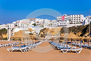 Rows of beach parasols with buildings