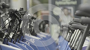 Rows of bicycles for rent. Action. A lot of identical bikes are in row. Street bikes for rent in modern city. Small