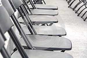 Rows of black folding chairs