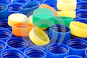 Rows of blue and colorful plastic lids - caps