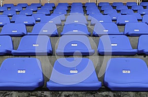 Rows of blue empty plastic chairs