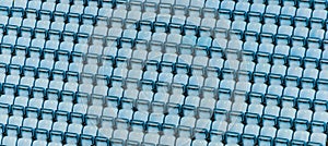 Rows of blue plastic stadium seats.