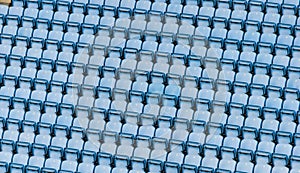 Rows of blue plastic stadium seats.