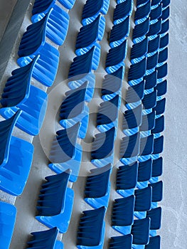 rows of blue seats for spectators in the stadium