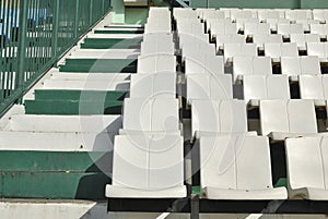 Rows of broken and stained white chairs an outdoor auditorium