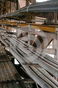 Rows of cable on a cable overpass. Outdoors industrial conduit corridor. Busbar gallery