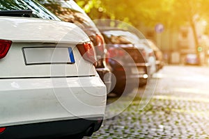 Rows of cars parked on the roadside in residential district