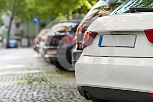 Rows of cars parked on the roadside in residential district